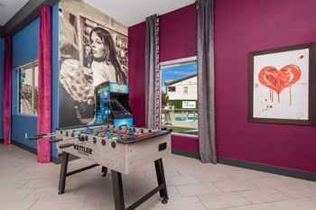 Resident clubhouse featuring billiards, retro arcade games, a photobooth, and stylish entertaining space